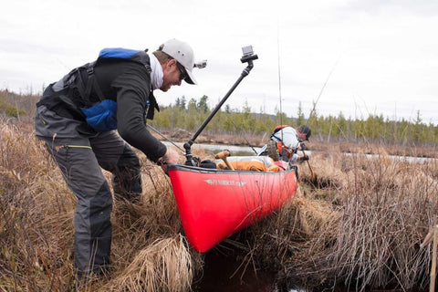 Canoeists paddling on a scenic waterway