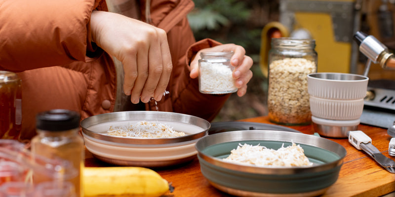 Overlanding couple prepares meal in two Sea to Summit collapsible bowls